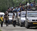 villagers leave their homes following ethnic clashes in Kokrajhar, Assam, on Tuesday. AP