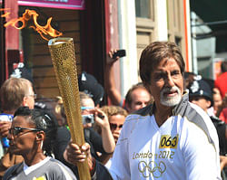 Actor Amitabh Bachchan carries the Olympic Flame in London on Thursday. AFP