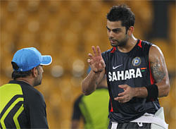 India's Virat Kohli, right, gestures at Mahendra Singh Dhoni during a warmup game of soccer ahead of their training session prior to their third ODI cricket match against Sri Lanka in Colombo, Sri Lanka, Friday, July 27, 2012. AP