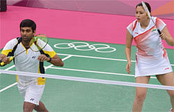 India's Diju V (L) and Jwala Gutta return to Indonesia's Lilyana Natsir and Ahmad Tontowi during their mix double group play stage at the London 2012 Olympic Games in London on July 28, 2012. Indonesia's Lilyana Natsir and Ahmad Tontowi won 21-16, 21-12. AFP