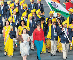 Flagbearer Sushil Kumar leads the delegation during the opening ceremony of the London 2012 Olympic Games on Saturday. The mystery woman is in red outfit . DH Photo / K N Shanth Kumar