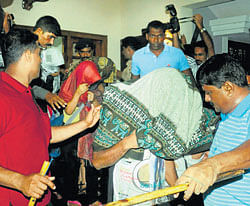 Victims being escorted by police in Mangalore on  Saturday. DH Photo