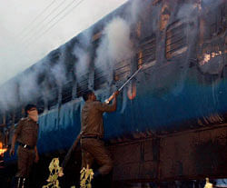 Fire personnel dousing a fire that broke out in a coach of the Chennai-bound Tamil Nadu Express near Nellore on early Monday morning after a suspected short circuit. PTI