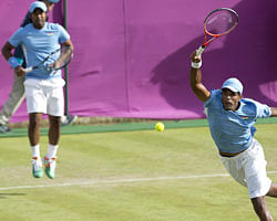 Leander Paes of India (L) watches as partner Vishnu Vardhan plays a rteturn during their men's first round doubles match against Netherland's Robin Haase and Jean-Julien Rojer for The 2012 London Olympic Games at the All England Tennis Club in Wimbledon, southwest London, on July 30, 2012. AFP
