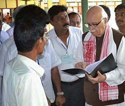 BJP senior leader LK Advani interacts with riot-hit people at Titaguri relief camp in Kokrajhar district on Monday. PTI