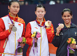 L to R: Silver medalist Wang Yihan of China, Gold medalist Li Xuerui of China and India's Saina Nehwal on the victory stand. DH photo