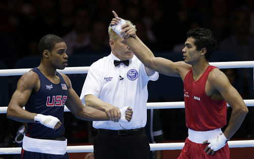 India's Krishan Vikas, right, reacts after defeating the United States' Errol Spence during a men's welterweight 69-kg preliminary boxing match at the 2012 Summer Olympics, Friday, Aug. 3, 2012, in London. (AP Photo/Ng Han Guan)