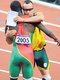 well done Olympic 400M champion Kirani James (left) hugs Oscar Pistorius. DH PHOTO / KN SHANTH KUMAR