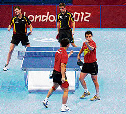 SUPER POWER Chinas Zhang Jike and Wang Hao play against Germanys Timo Boll and Bastian Steger in the mens team semifinal table tennis match at the ExCel centre on Monday. AFP
