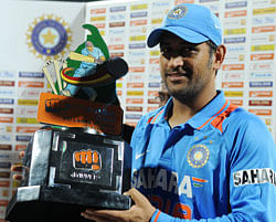 Indian cricket team captain Mahendra Singh Dhoni holds the trophy after his team's victory in the Twenty20 match between Sri Lanka and India at the Pallekele International Cricket Stadium in Pallekele on August 7, 2012. AFP