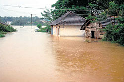 marooned: Flood water from River Nethravati  entered several houses at Pane Mangalore in Dakshina Kannada district on Tuesday. KPN
