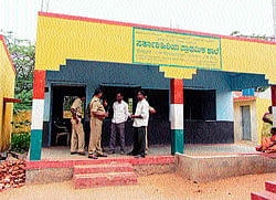 Police personnel at the Government Higher Primary School at Krishnapura in Yalandur taluk, Chamarajanagar district, where students took mass leave on Monday and Tuesday, demanding grant of government land for the school. dh photo