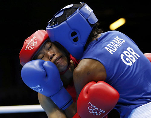 India's Chungneijang Mery Kom Hmangte (L) fights Britain's Nicola Adams during their Women's Fly (51kg) semi-final boxing match at the London Olympic Games August 8, 2012. REUTERS/Damir Sagolj