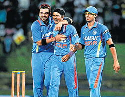 young heroes: Virat Kohli (left) and Ashok Dinda (centre) played a huge role in Indias win on Tuesday. AFP