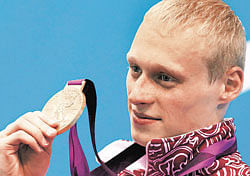 momentous Russian Ilya Zakharov poses with the 3M springboard diving gold medal in London. reuters
