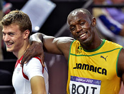 Jamaica's Usain Bolt jokes with France's Christophe Lemaitre after their men's 200-meter semifinal races during the athletics in the Olympic Stadium at the 2012 Summer Olympics, London, Wednesday, Aug. 8, 2012. AP