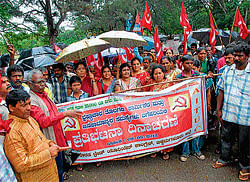 Office-bearers of United Plantation Workers Union Kodagu district unit staging a protest in Madikeri urging the government to meet their several demands on Thursday. (Right) Protesters led by AITUC stage a protest in Chikmagalur on Thursday, demanding fulfillment of their long-pending demands.
