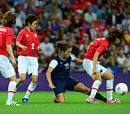 United States's midfielder Carli Lloyd (C) escapes Japan's players during the final of the women's football competition of the London 2012 Olympic Games USA vs Japan on August 9, 2012 at Wembley stadium in London. The US team defeatd Japan 2-1 to win the gold medal. AFP