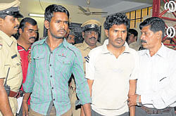 Way to jail: Accused Raghu and Shekar being produced before the media at Vidyaranyapuram police station in Mysore on&#8200;Saturday. DH Photo