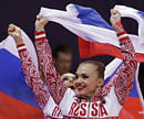 Members of gold medallist team Russia wave their national flag and celebrate during the rhythmic gymnastics group all-around final at the 2012 Summer Olympics, Sunday, Aug. 12, 2012, in London. AP
