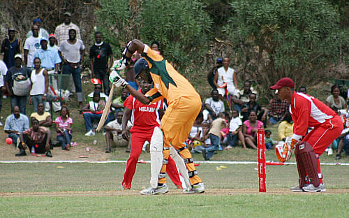 This file photo taken on October 18, 2009 shows Olympic 100m champion and world record holder Usain Bolt (C-in orange) participating in a charity invitational celebrity cricket match at the Kaiser Sports facility in St. Ann, Jamaica. Negotiations are underway for cricket-mad sprint king Usain Bolt to play in Australia's Twenty20 Big Bash League, with Shane Warne leading the campaign to bring him to Melbourne, it was reported on Australian television on August 12, 2012. AFP PHOTO / FILES