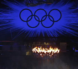 The Olympic Flame burns as the Olympic Rings stand illuminated during the Closing Ceremony at the 2012 Summer Olympics, Sunday, Aug. 12, 2012, in London. (AP Photo