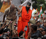 Ramdev being detained by police in New Delhi on Monday. PTI