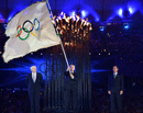 London Mayor, Boris Johnson, second from left, watches as the International Olympic Committee President Jacques Rogge, center, hands the Olympic flag to the Mayor of Rio de Janeiro, Eduardo Paes, right, during the Closing Ceremony of the 2012 Summer Olympic on Sunday, Aug. 12, 2012, in London. AP