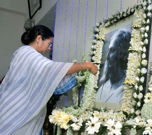 West Bengal Chief Minister Mamata Banerjee pays tribute to Rabindranath Tagore on his 71st death anniversary at Writers Building in Kolkata on Tuesday. PTI Photo