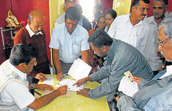 District in-charge minister Appachu Ranjan receives grievances from public at his office in Somwarpet. DH Photo