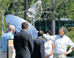 Bill Gates looks at a device that uses solar energy to treat human waste, as he tours the 'Reinventing the Toliet' Fair, on Tuesday, in Seattle, part of a Bill & Melinda Gates Foundation competition to reinvent the toilet for the 2.6 billion people around the world without modern sanitation. AP