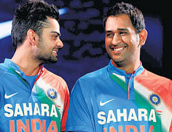 colours of india: Skipper Mahendra Singh Dhoni and Virat Kohli share a light moment during the unveiling of Indias new T20 jersey in Mumbai on&#8200;Thursday. AP