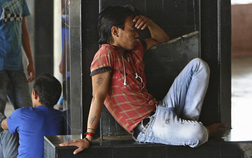 A man from a northeastern state, takes a nap at a platform while waiting for a train to board back to his home at a railway station in Chennai on August 17, 2012.  Reuters.