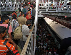 People from India's northeastern states, walk at the platform upon their return from southern Indian states, at the railway station in Guwahati in the northeastern Indian state of Assam August 18, 2012. Indian Prime Minister Manmohan Singh assured migrants from the northeast that they were safe as thousands fled Mumbai, Bangalore and other cities on Friday, fearing a backlash from violence against Muslims in Assam. REUTERS