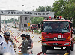 Pakistani firefighters leave the Minsas Air Force base after the completion of a commando operation against armed militants in Kamra, about 60 kilometres northwest of Islamabad, on August 16, 2012. Heavily armed militants stormed a Pakistani air force base August 16, sparking clashes that left 10 people dead and raised concerns about the safety of the country's nuclear arsenal. AFP PHOTO