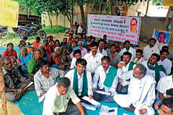 Residents of Vivekanandanagar in Mulbagal stage a protest on Friday against eviction from their huts.&#8200;DH Photo