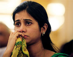 The wife of Indian cricketer V.V.S. Laxman, Sailaja, reacts after Laxman, unseen, announced his retirement, at the Rajiv Gandhi International cricket stadium in Hyderabad, India, Saturday, Aug. 18, 2012. The elegant strokes of Laxman will no longer be seen on the international stage after one of India's most celebrated test batsmen announced his retirement on Saturday. (AP Photo