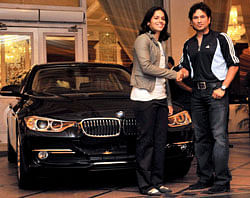 Indian badminton star and Olympics Bronze Medallist Saina Nehwal being gifted a BMW car by cricketer Sachin Tendulkar at a felicitation event, in Hyderabad on Sunday. PTI Photo