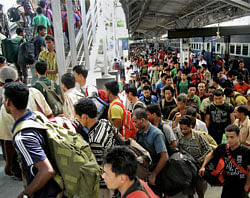 North East migrants, who fled from different parts of India after rumours of attacks, on their arrival at Guwahati railway station on Sunday.PTI Photo