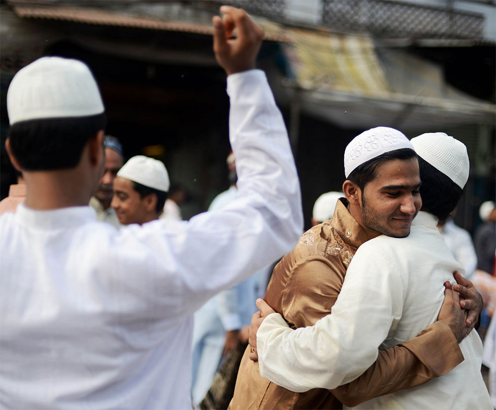Indian Muslims embrace after offering Eid al-Fitr prayers near the Jama Masjid Mosque in the old quarters of New Delhi on August 20, 2012. Millions of Muslims across Asia began celebrating the Eid al-Fitr holiday on August 19, with a month of fasting giving way to feasting, family reunions and raucous festivities. India has the second largest population of Muslim followers in the world with over 150 million faithful. AFP PHOTO