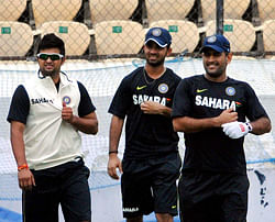 Skipper MS Dhoni with Ajinkya Rahane and Suresh Raina at practice session at Rajiv Gandhi International Cricket Stadium in Hyderabad on Tuesday. India and New Zealand will play the first of their two test cricket series from Aug. 23 in Hyderabad. PTI
