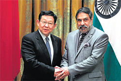 Commerce & Industry Minister Anand Sharma  shakes hands with his Chinese counterpart Chen Deming in New Delhi PTI