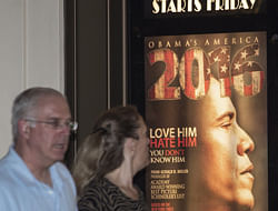 An unidentified couple walk by the Rave Fairfax Corner movie theater in Fairfax, Virginia showing a billboard of the new movie '2016: Obama's America,' which opened in theaters across the US August 24, 2012. There's nothing like going to the movies on a rainy day, and in storm-drenched Tampa Republicans have flocked to '2016: Obama's America,' a right-wing documentary and surprise box-office hit. The film provides a dark vision of what would happen if President Barack Obama wins a second term in the November 6 election, which delegates to the Republican National Convention here are determined to prevent. AFP PHOTO/Paul J. Richard
