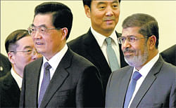 REAL INFLUENCE: Egyptian President Mohammed Morsi, right, and Chinese President Hu Jintao, second left, attend a welcome ceremony held at the Great Hall of the People in Beijing on Tuesday. AP
