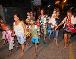 Residents living in a coastal village evacuate to higher grounds after receiving a tsunami warning from the local authorities after an earthquake hits Catarman, Northern Samar, central Philippines August 31, 2012. An earthquake of 7.6 magnitude struck off the Philippines on Friday killing one person, damaging roads and bridges and sending people fleeing to higher ground in fear of a tsunami, a politician and authorities said. Picture taken August 31, 2012. REUTERS
