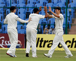 New Zealand's Trent Boult (R) celebrates with teammates after taking a catch off the bowling of teammate Tim Southee to dismiss India's Cheteshwar Pujara during the second day of their second test cricket match in Bangalore, September 1, 2012. REUTERS