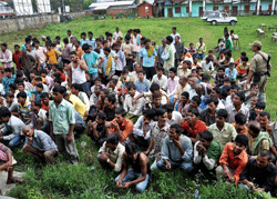 People, suspected to be illegal immigrants from neighbouring countries, held up by the police in Imphal. PTI Photo