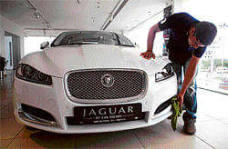 driving force: An employee cleans a Jaguar XF at the AMP Motors showroom in Gurgaon. NYT