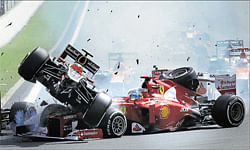 CRAASH: Lotus Romain Grosjean (left) crashes with Ferraris Fernando Alonso during the first lap of the Belgian Grand Prix on&#8200;Sunday. AFP