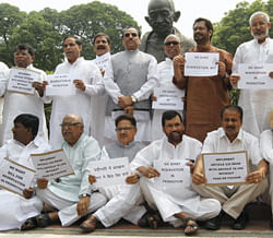 SC/ST MPs staging a protest for quota in promotion at Parliament in New Delhi on Friday. PTI